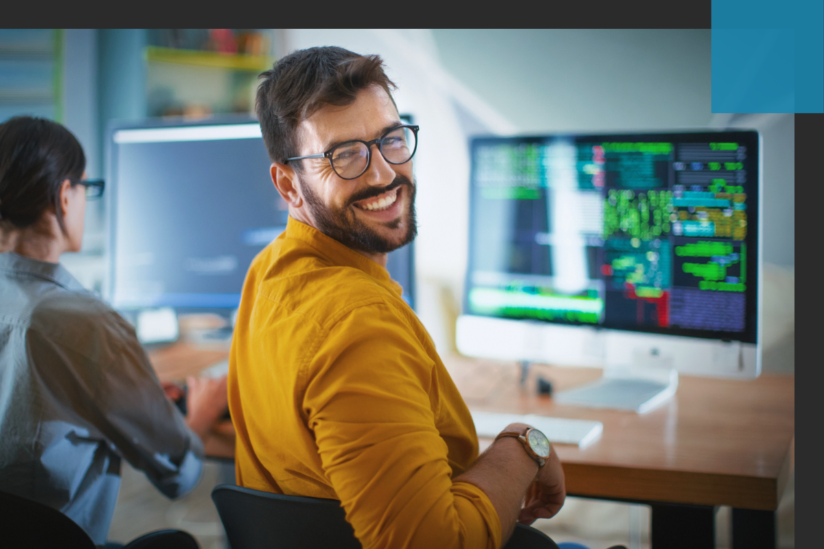 Developer smiling at computer
