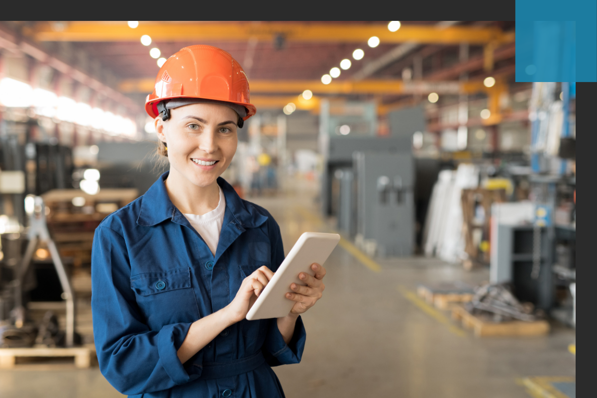 Smiling woman in warehouse holding a tablet
